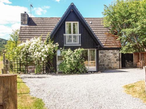 a house with a stone driveway in front of it at Inshcraig in Kincraig