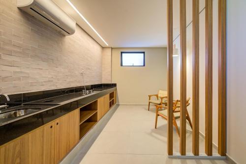 a kitchen with a sink and a table at Cyan Resort by Atlantica in Itupeva