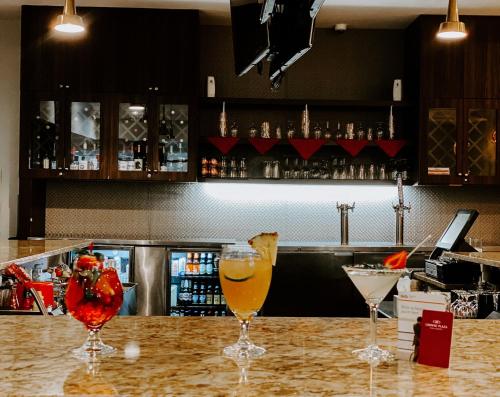 two wine glasses sitting on top of a bar at Crowne Plaza Chicago SW - Burr Ridge by IHG in Burr Ridge