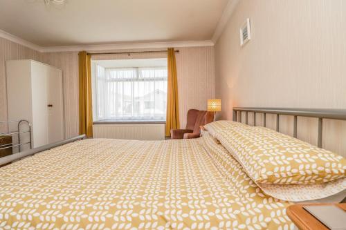 a bedroom with a large bed and a window at Echo Beach in Seasalter