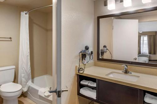 a bathroom with a sink and a toilet and a mirror at Best Western Country Inn Temecula in Temecula