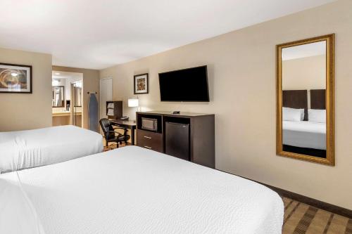 a hotel room with two beds and a mirror at Best Western Country Inn Temecula in Temecula