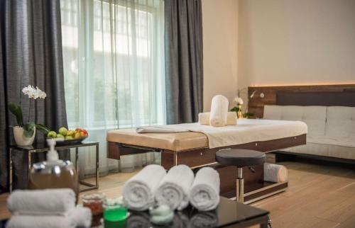 a living room with a bed and a couch at Radisson Collection Hotel, Old Mill Belgrade in Belgrade