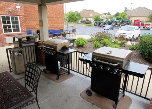 a patio with two bbqs and a grill at Sonesta Simply Suites Columbus Airport Gahanna in Gahanna