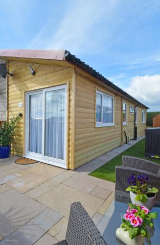 a cabin with a large sliding door on a patio at Pet friendly sleeps 3 Chalet Bridlington free elec in Bridlington