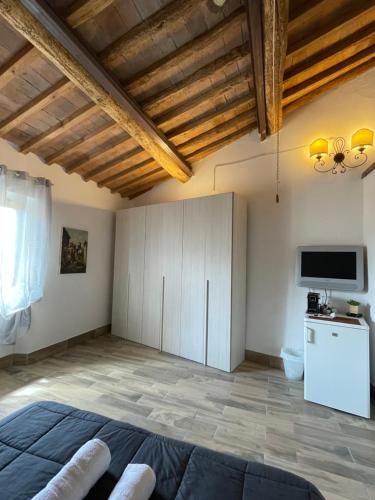 a bedroom with a bed and a flat screen tv at Il Feudo in Certaldo