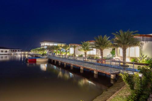 a view of a canal at night with palm trees at Lumbini Palace Resort in Lumbini