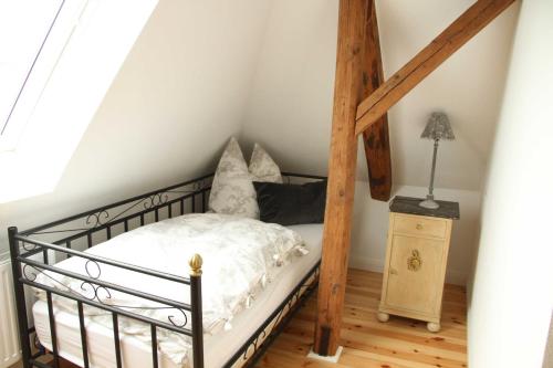 a bedroom with a bed and a wooden pole at B&B Angeliter Landidyll in Gelting