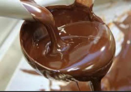 a spoonful of chocolate on top of a doughnut at Beachfront Paradise in Manuel Antonio