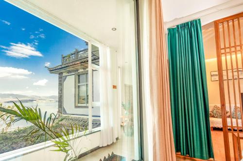 a balcony with a view of the eiffel tower at Blue Sea Hotel in Dali