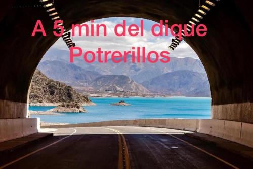 a km del divide of potethics written on a road at Mirador de Montaña in Ciudad Lujan de Cuyo