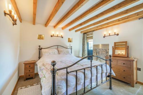 a bedroom with a bed and a wooden ceiling at Basil's Barn in Whitby