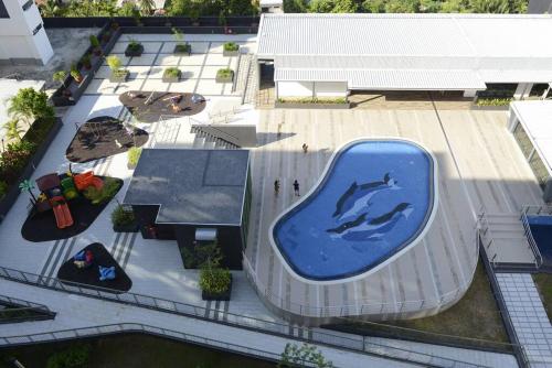 a swimming pool with a dolphin painted on the side of a building at 8pax Cozy Home Stay Jazz Suites 1 Vivacity Kuching Sarawak 3BR in Kuching