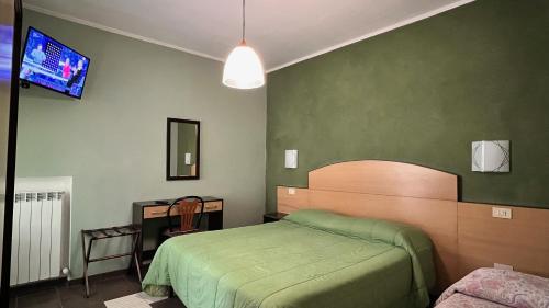 Postel nebo postele na pokoji v ubytování Hotel Il Cavaliere Nero