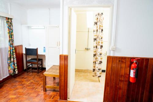 a living room with a fire hydrant and a door at Naro Moru River Lodge in Naro Moru