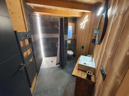 an overhead view of a bathroom with a sink and shower at Chalet cosy et moderne vue montagnes in Seytroux