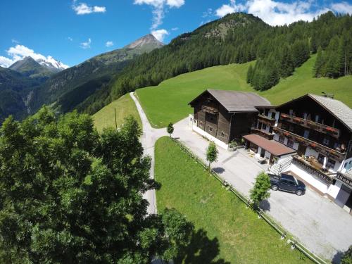 an aerial view of a building in the mountains at Ferienhof Oberer Gollmitzer in Heiligenblut