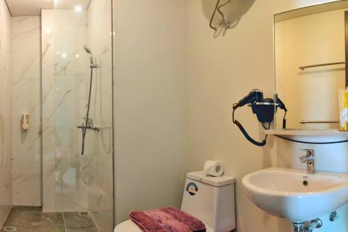 a bathroom with a shower and a toilet and a sink at Lovina 16-AE at One Residence(near Ferry Terminal) in Batam Center