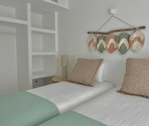 a bedroom with two beds with pillows on them at Cedros Nature House in Sintra