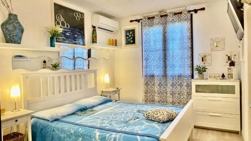 a bedroom with a bed and a window at Deluxe Apartments in Porto Rotondo in Porto Rotondo