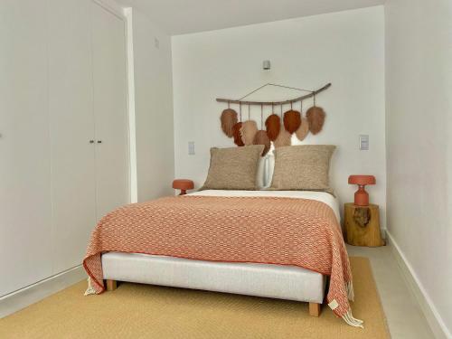 a bedroom with a bed with a wooden headboard at Cedros Nature House in Sintra