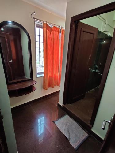 a bathroom with a large mirror and a window at Gangavaram Residency in Cuddapah