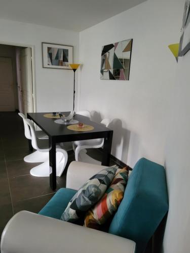 里昂的住宿－Appartement privée Lyon 3，客厅配有桌子和蓝色沙发