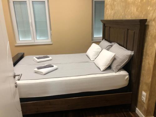 a bed with two towels on top of it at Swiss Central Luxury Apartment 132m2 in Sarajevo