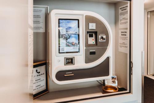 an atm machine in a display case at Emma's B&B - Self Check-in Hotel in Lungern