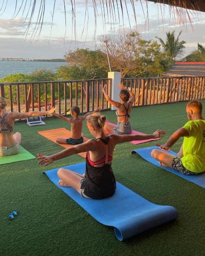 a group of people sitting in a yoga class at MKS - Kite & Wing Foil camp in Kalpitiya