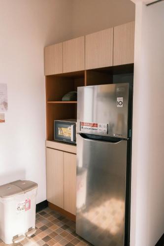 a kitchen with a stainless steel refrigerator in a kitchen at South Gate Home Stay in Tainan
