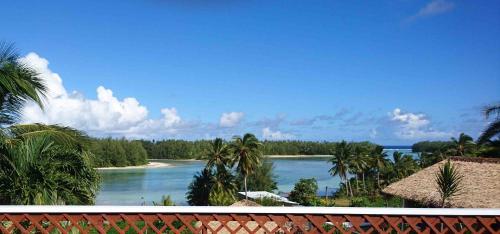 a view of a body of water with palm trees at Muri Motu Outlook in Rarotonga
