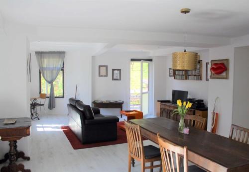 a living room with a table and a couch at La casa di Arnaldo La cuccia in Agno