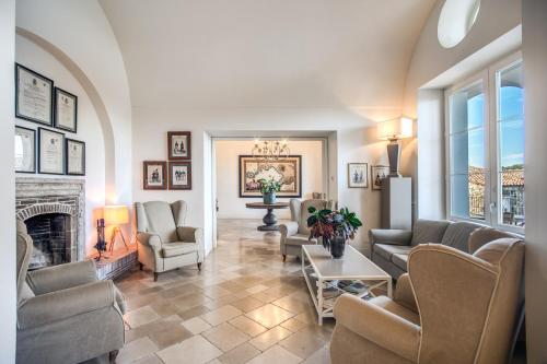a living room with couches and a fireplace at Relais Palazzo del Barone in Sorrento