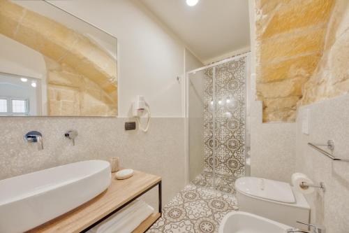 a bathroom with a sink and a toilet and a shower at Michelangelo B&B in Lecce
