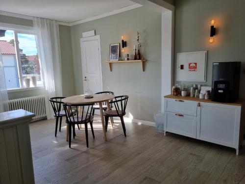 a kitchen with a table and chairs in a room at Byske Gästgivargård in Byske