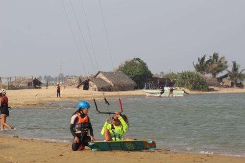 a couple of people on the beach with a kite at MKS - Kite & Wing Foil camp in Kalpitiya