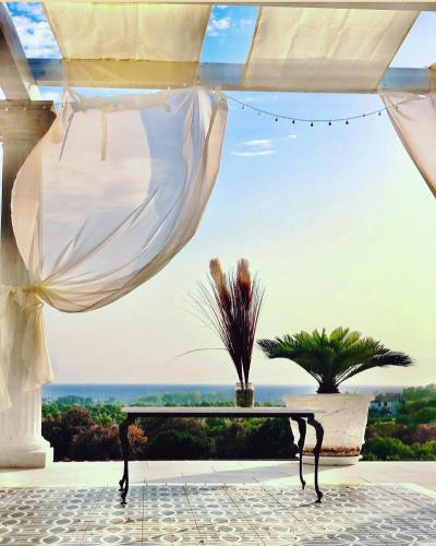 a table on a patio with a view of the ocean at L'incanto di Nausicaa in Ascea