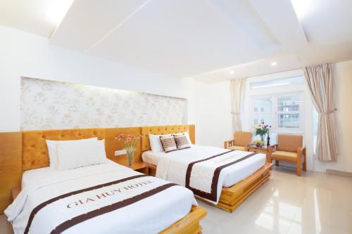 a hotel room with two beds and a window at Gia Huy Hotel in Ho Chi Minh City