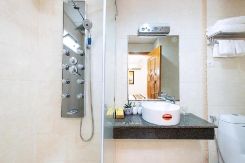 a bathroom with a sink and a shower at Gia Huy Hotel in Ho Chi Minh City