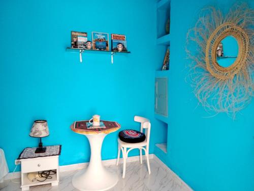 a blue room with a table and a chair at Dar Hkaïem in Sousse