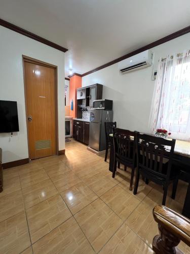 a living room with a table and chairs and a kitchen at Affordable La Union in Caba