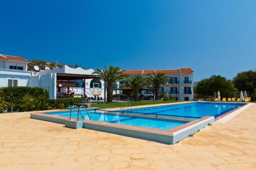 a large swimming pool in front of a building at Saint Nicholas Hotel in Psili Ammos