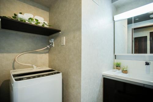 a small kitchen with a stove and a sink at Vacation Rent 金沢 in Kanazawa
