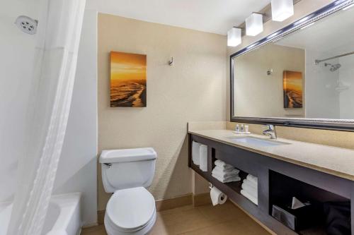 a bathroom with a toilet and a sink and a mirror at Comfort Inn San Diego Old Town in San Diego