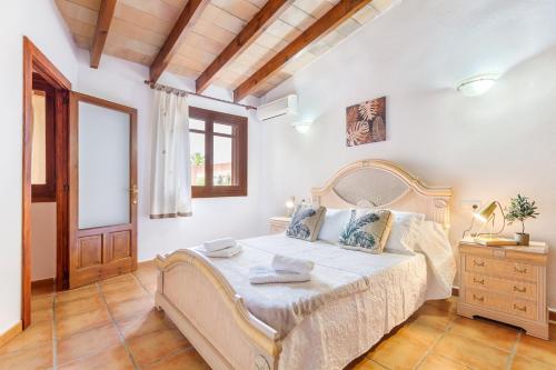 a bedroom with a large bed in a room at Marilen - Finca with Large Garden & Pool in Alcudia