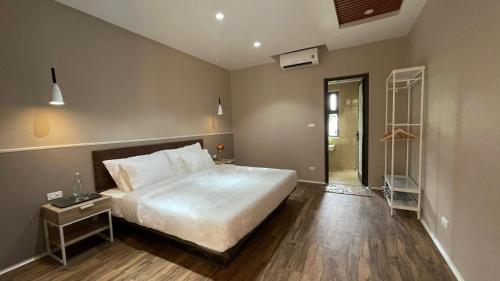 a bedroom with a large bed and a walk in shower at PHOENIX MINH CHÂU HOTEL in Quang Ninh