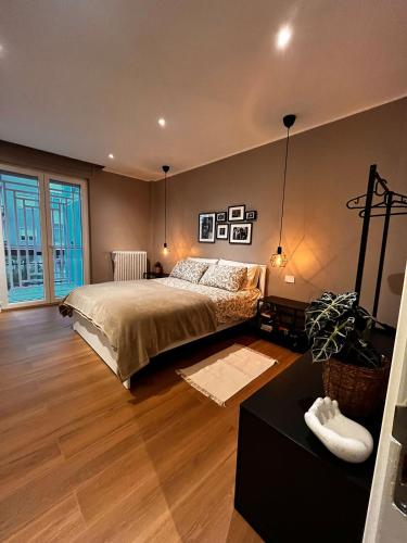 a bedroom with a large bed and a large window at DeGasperi Studio Apartment in Trani