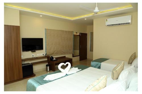 a hotel room with two beds with a heart on them at CORAL RESIDENCY in Rāmanāthapuram
