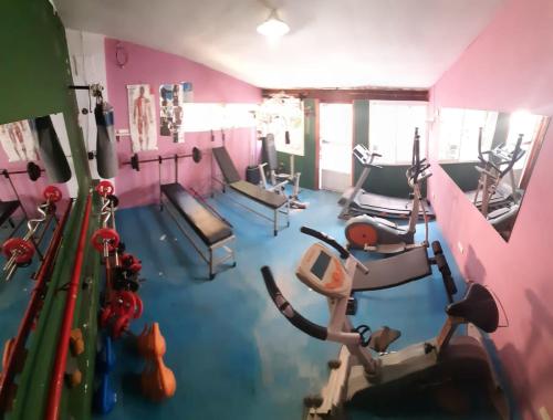 a gym with several treadmills and exercise bikes at Hotel Brisas Marinas in San Clemente del Tuyú